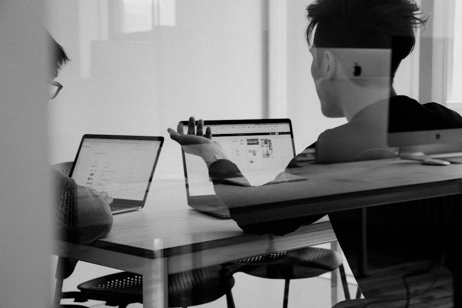 A monochrome shot of a developer working at a laptop