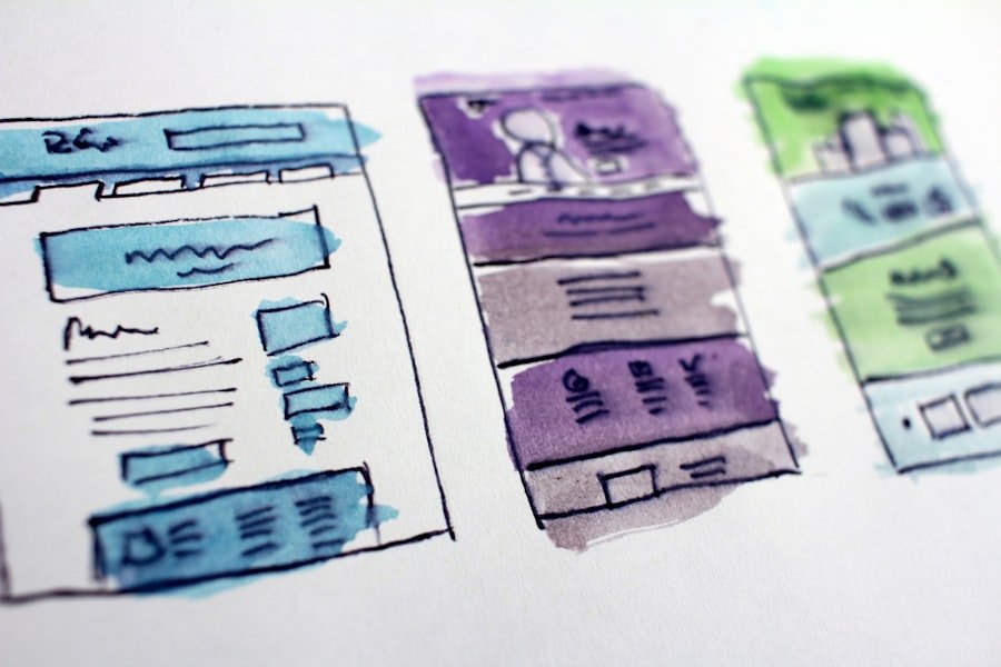 Hand-drawn interface wireframes laid out on a desk