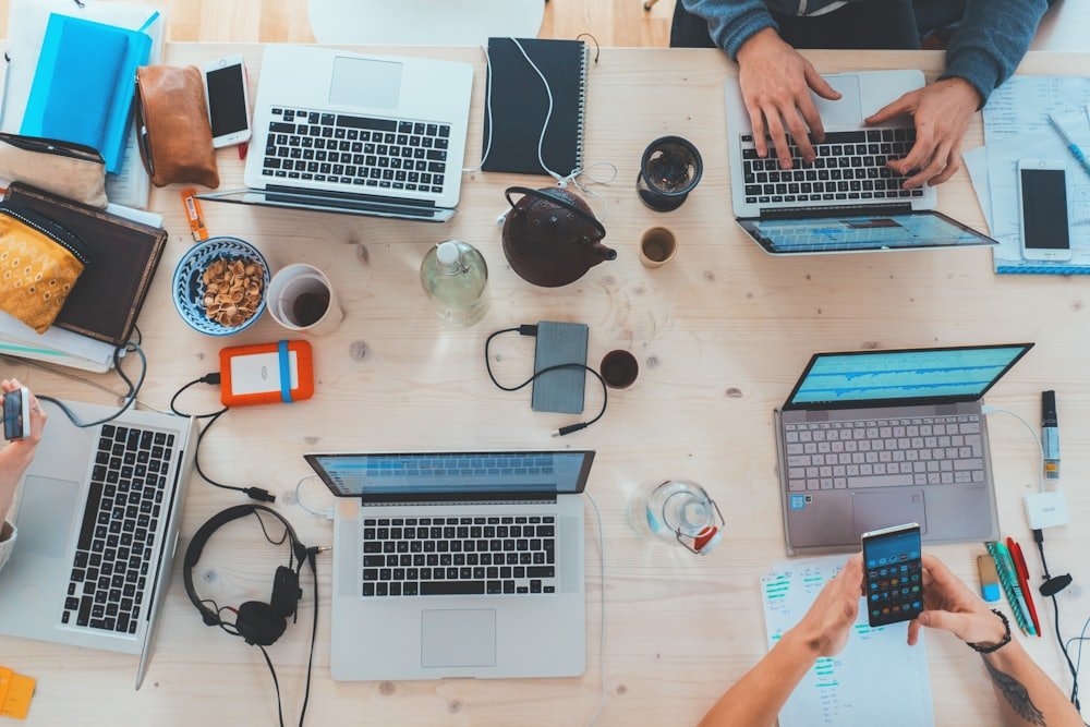 Designers and developers working across laptops on a shared desk